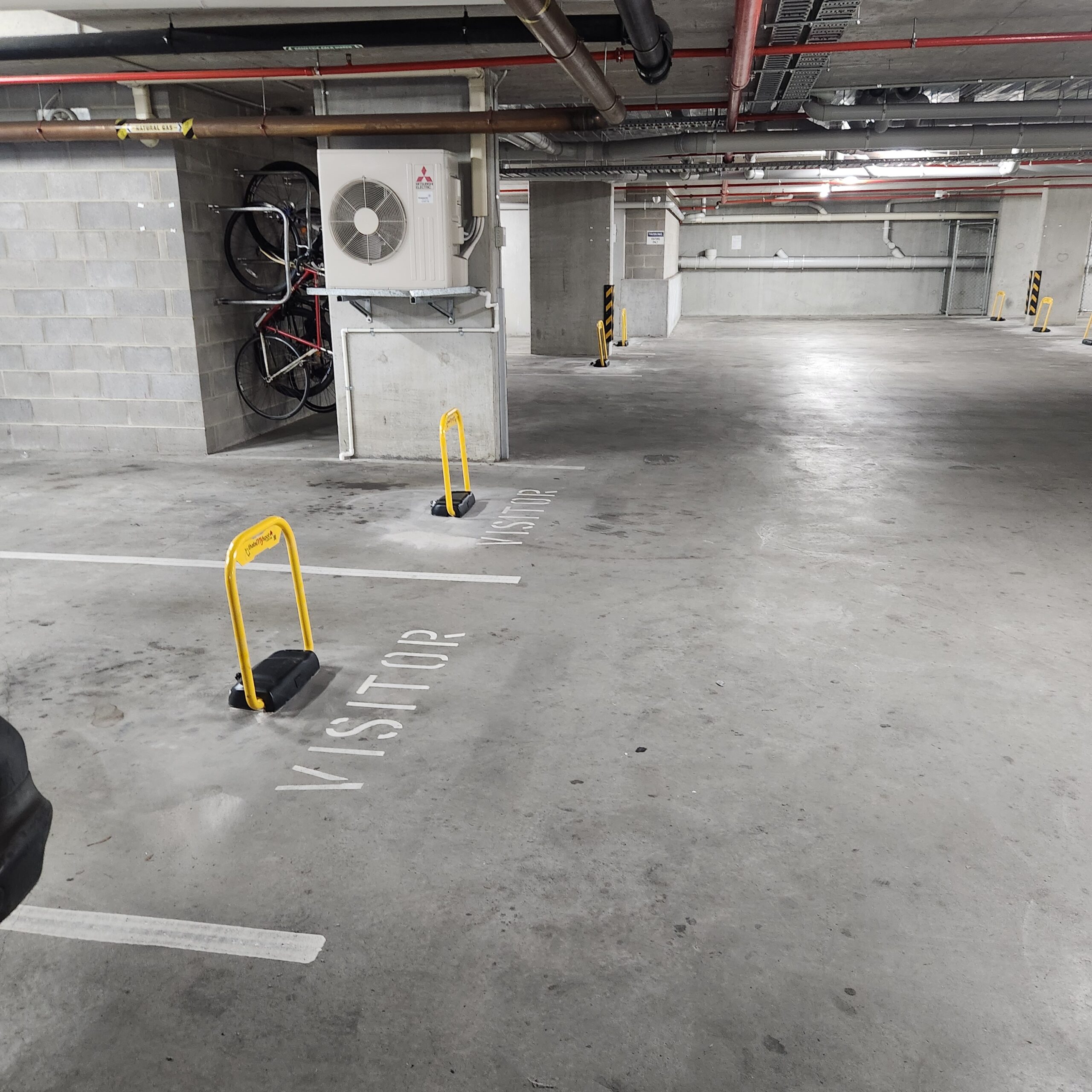 Extra-tall-smartphone-parking-bollards-installed-in-visitor-parking-in-brisbane thatsmyspot parking bollards for for visitor parking and commercial parking and industrial parking and hotel parking and EV charging