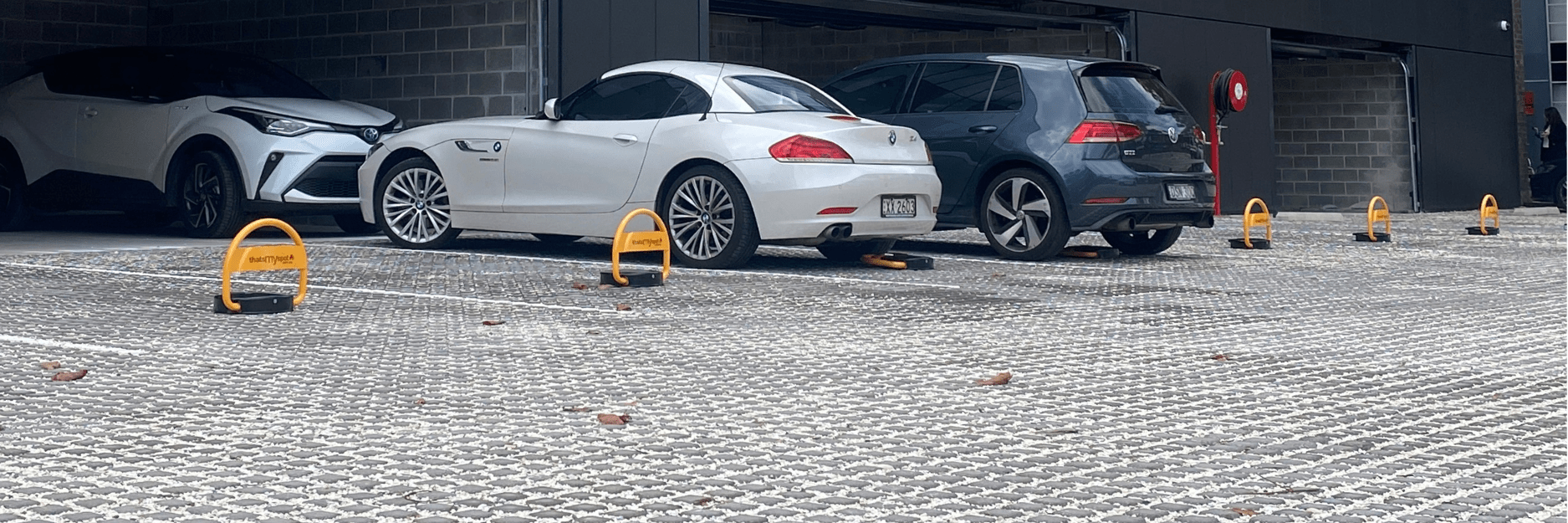 thatsmyspot remote-control-parking-bollards-installed-at-commercial-property-site-goodman-rosebery-engine-yards thatsmyspot parking bollards for for visitor parking and commercial parking and industrial parking and hotel parking with logos and wide angle view