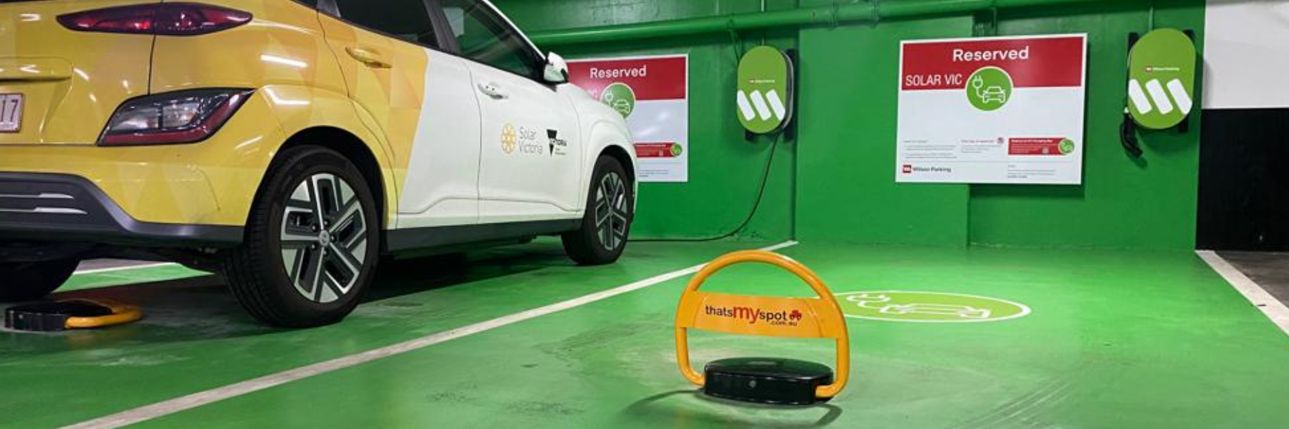 thatsmyspot remote control parking bollards installed in Wilson Parking ev charging bays in Melbourne to stop ICEIng and unauthorised parking with yellow car